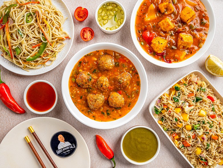 Overhead spread of noodles, fried rice, Manchurian and Cheese Chilly