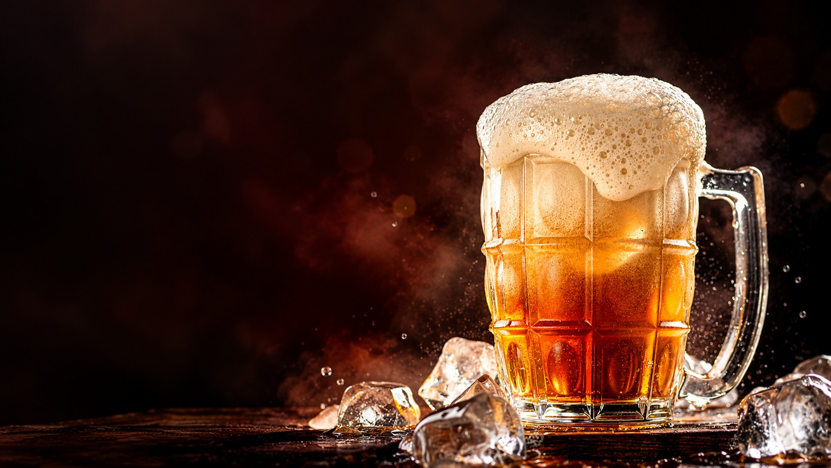 A frosty mug of Pyaar Wali Fruit Beer overflowing with froth, surrounded by ice