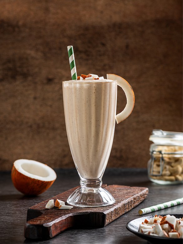 Coconut Shake in a tall glass with a striped straw
